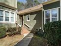 Side view of house with brick steps leading to the front door at 5917 Sentinel Dr, Raleigh, NC 27609