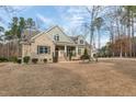 Landscaped brick home featuring a side entry garage, mature trees, and a manicured lawn at 6236 Annabella Rd, Rocky Mount, NC 27803