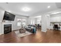 Inviting living room featuring a cozy fireplace, hardwood floors, and comfortable seating at 624 Metro Station, Apex, NC 27502