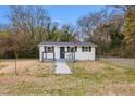 Charming home with a well-kept yard and a secure fence, perfect for outdoor activities and relaxation at 700 Ross Rd, Lillington, NC 27546