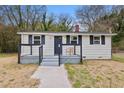 Inviting front porch with updated railings and room for seating, providing a cozy outdoor space at 700 Ross Rd, Lillington, NC 27546
