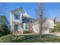 Inviting two-story home with brick accents, lush lawn, and a charming covered front entrance at 708 Barley Green St, Wake Forest, NC 27587