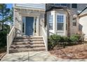 Welcoming front porch with brick steps leading to a blue front door and a bright bay window at 708 Barley Green St, Wake Forest, NC 27587