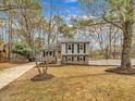 Charming two-story home with gray siding, brick foundation, black shutters, and a well-maintained front yard at 1041 Limerick Ln, Durham, NC 27713