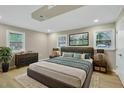 Spacious bedroom with a king-size bed, neutral tones, ample natural light, and stylish decor at 1041 Limerick Ln, Durham, NC 27713