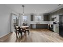 Open kitchen with stainless steel appliances, eat in dining, neutral color cabinets, and hardwood floors at 1104 Pebblestone Dr, Durham, NC 27703