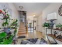 Bright entryway with staircase, stylish decor, and tile flooring, creating a welcoming atmosphere at 11843 Canemount St, Raleigh, NC 27614