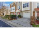 Well-maintained townhome featuring stone accents, an attached garage and mature landscaping at 11843 Canemount St, Raleigh, NC 27614