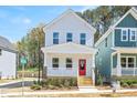 Charming two-story home featuring a welcoming front porch with a vibrant red door at 122 Weavers Grove Dr, Chapel Hill, NC 27514