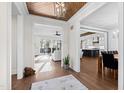 Bright foyer showcasing hardwood floors, an elegant ceiling design, and open access to the living spaces at 1636 Sweetwater Ln, Raleigh, NC 27610