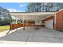 Spacious carport with a covered deck and access to the house at 200 Arlington Cir Cir, Sanford, NC 27330