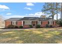 Beautiful brick home with a well-maintained lawn, inviting front porch, and mature trees at 200 Arlington Cir Cir, Sanford, NC 27330
