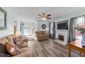 Comfortable living room with a fireplace, ceiling fan, and a view of the front yard at 214 Linville Ln, Willow Springs, NC 27592