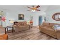 Cozy living room with two couches, ceiling fan, and a view of the front entrance at 214 Linville Ln, Willow Springs, NC 27592