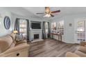 Bright living room features a fireplace, ceiling fan, and ample natural light at 214 Linville Ln, Willow Springs, NC 27592