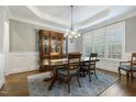 Elegant dining room featuring a coffered ceiling, hardwood floors, and plantation shutters at 242 Sweet Pine Cir, Pittsboro, NC 27312