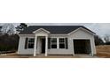 Welcoming single-story home featuring light siding, dark shutters, covered entryway, and convenient garage at 272 Johnson Ridge Way, Four Oaks, NC 27524
