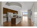 Spacious kitchen featuring hardwood floors, stainless steel appliances, and a large center island at 301 Fayetteville St # 3205, Raleigh, NC 27601