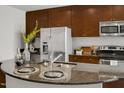 Close up on island with granite countertops and stainless steel sink in gourmet kitchen at 301 Fayetteville St # 3205, Raleigh, NC 27601