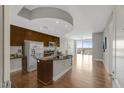 Open kitchen with island, wood floors, stainless appliances and a seamless transition to the living space at 301 Fayetteville St # 3205, Raleigh, NC 27601