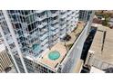 Aerial view of a rooftop pool and outdoor lounge area perfect for relaxing and entertaining in a modern building at 301 Fayetteville St # 3205, Raleigh, NC 27601