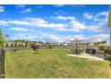 Large backyard with a lush lawn, a patio seating area with an umbrella, and a wood privacy fence at 310 Mineral Spring Ln, Fuquay Varina, NC 27526