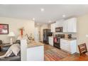 Modern kitchen features white cabinets, granite countertops, and black appliances at 310 Mineral Spring Ln, Fuquay Varina, NC 27526