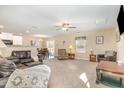 Spacious living room featuring neutral walls, plush carpet, and comfortable seating with ample natural light at 310 Mineral Spring Ln, Fuquay Varina, NC 27526
