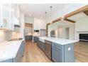Open-concept kitchen featuring a large island, stainless steel appliances, and custom cabinets at 4225 Burlington Mills Rd, Wake Forest, NC 27587