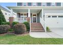 Inviting front porch with brick accents and manicured landscaping leads to the main entrance at 4508 Brintons Cottage St, Raleigh, NC 27616