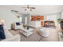 Bright and open living room with hardwood floors seamlessly connects to the kitchen and dining area at 4508 Brintons Cottage St, Raleigh, NC 27616