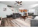 Open-concept living room with wood floors, ceiling fan, and neutral color palette at 4508 Brintons Cottage St, Raleigh, NC 27616