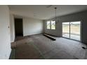 Bright living room with recessed lighting, large windows, and sliding door, offering ample natural light at 51 Robert Howe Dr, Fuquay Varina, NC 27526