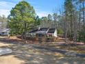 Aerial view of home showing back deck and large lot surrounded by mature trees at 573 Broadmoor Ct, Sanford, NC 27332