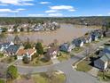An aerial view captures homes nestled near a serene lake, offering a picturesque neighborhood setting at 715 Southshore Pkwy, Durham, NC 27703