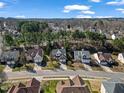 An aerial view showcases a neighborhood street lined with well-maintained homes and mature trees at 715 Southshore Pkwy, Durham, NC 27703