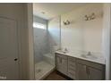 Modern bathroom with a dual sink vanity, a large frameless mirror, and a luxurious shower with a bench at 720 Hipwood Dr, Zebulon, NC 27597