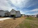 New construction home with light siding, two-car garage, and a spacious yard in a growing community at 720 Hipwood Dr, Zebulon, NC 27597