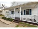 Inviting front porch with decorative railings and wood flooring, offering a cozy entrance to the home at 847 Estes St, Durham, NC 27701