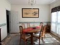 Traditional dining room with a chandelier, wooden table with seating for six, and decorative wall art at 100 Sandy Hook Way, Cary, NC 27513