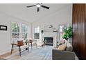 Bright living room with a fireplace, grey sofa and chairs, featuring lots of natural light at 1109 Sorcerer Ct Ct, Knightdale, NC 27545