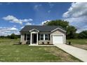 Charming single-story home with vinyl siding, black shutters, and a well-manicured front yard at 114 Johnson Ridge Way, Four Oaks, NC 27524