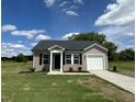 Charming single-story home with vinyl siding, black shutters, and a well-manicured front yard at 114 Johnson Ridge Way, Four Oaks, NC 27524