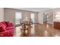 Bright living room with hardwood floors, large windows, and comfortable seating arrangement at 115 Perth Pl, Durham, NC 27712