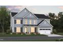 A charming two-story blue home with a two-car garage and beautiful lawn at 1208 Opal Ln # 92, Durham, NC 27705