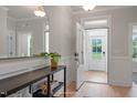 Inviting entryway showcasing wood floors, wainscoting, a large mirror, and a glimpse of the outdoors at 1783 Ballard Rd # Apex Georgian, Fuquay Varina, NC 27526