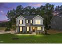 Charming two-story home at dusk with gray siding, black shutters, and a well-manicured lawn at 1803 Ballard Rd # Holly Craftsman, Fuquay Varina, NC 27526