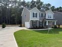 Two-story gray home featuring a two car garage and a spacious lawn at 1803 Ballard Rd # Holly Craftsman, Fuquay Varina, NC 27526