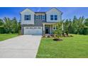 Charming two-story home featuring a welcoming entrance, a two car garage and landscaped front yard at 1803 Ballard Rd # Holly Craftsman, Fuquay Varina, NC 27526