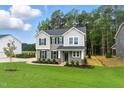 Beautiful two-story home with landscaped front yard and gray siding and well manicured lawn at 1803 Ballard Rd # Holly Craftsman, Fuquay Varina, NC 27526